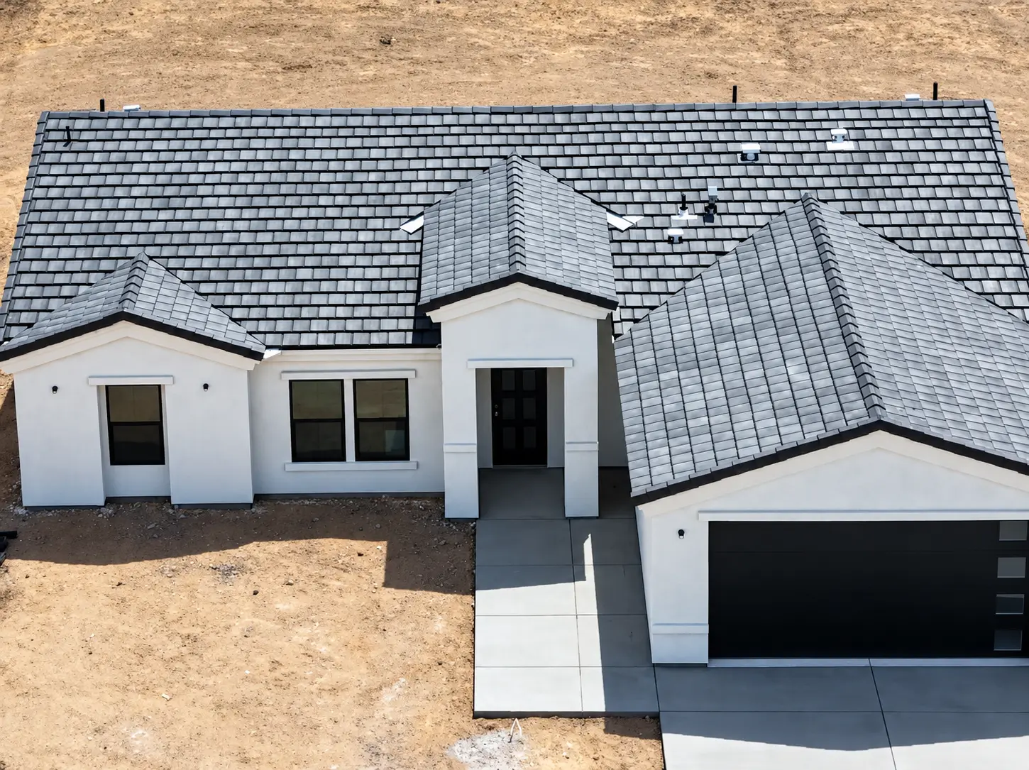 Aerial view of a finished home with a gray roof